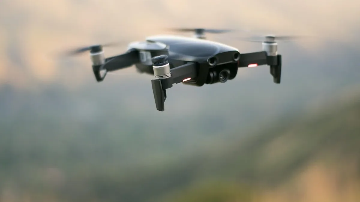 A small drone flying in the air, with its propellers spinning and its camera lens visible.