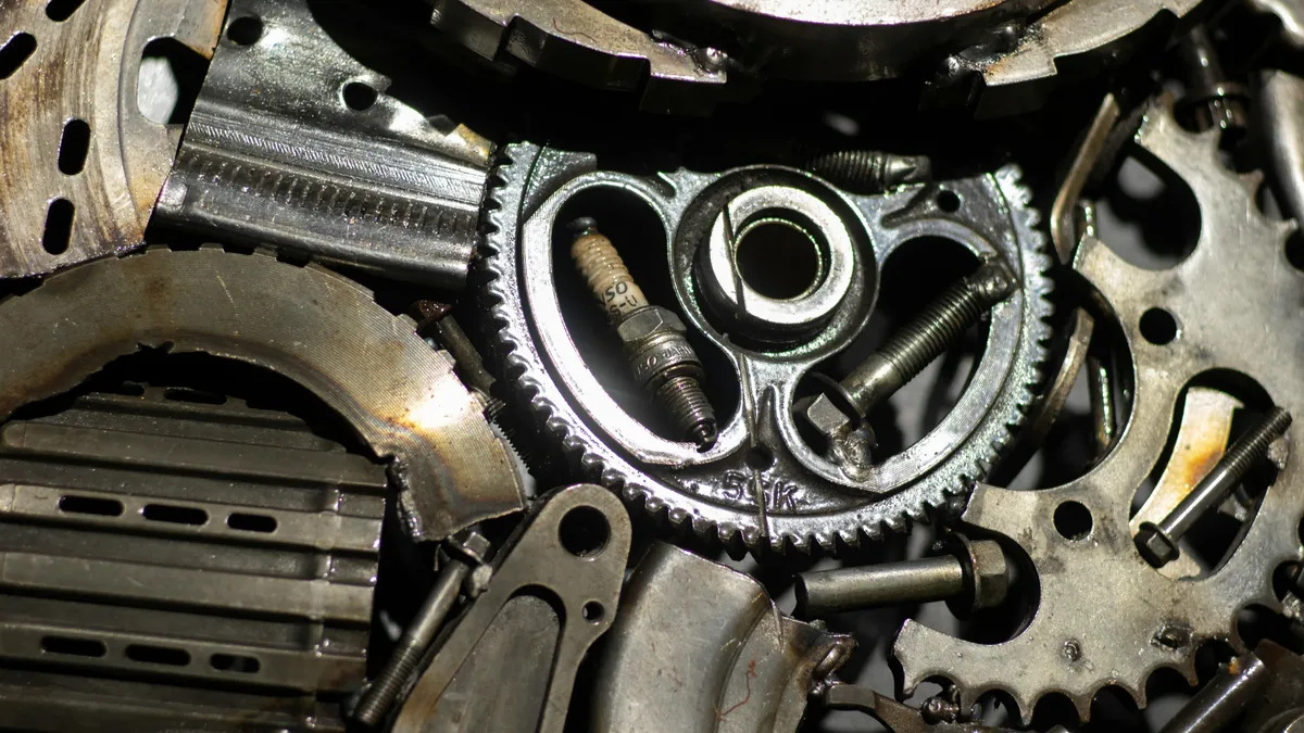 A close-up view of a disassembled engine, with visible components including gears, bolts, and other metal parts.